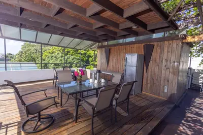 a patio with a table and chairs on a deck at Casa La Maria Zona Colonial in Santo Domingo