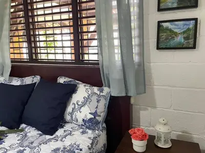 a blue and white couch in a room with a window at Villa Carmen en Jarabacoa in La Represa