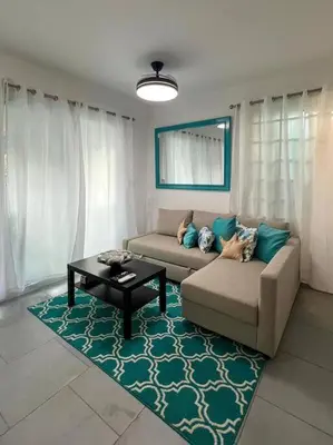 a living room with a couch and a coffee table at A private cozy-beach apartment in Dominicus in La Laguna