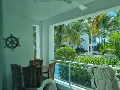 a view from the balcony of a resort with a table and chairs at A private cozy-beach apartment in Dominicus in La Laguna