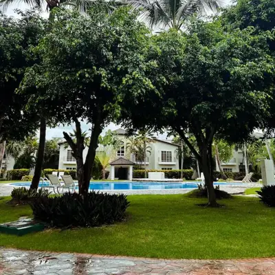 a resort yard with trees and a swimming pool at Apartamento en Punta Cana, White sands in Punta Cana