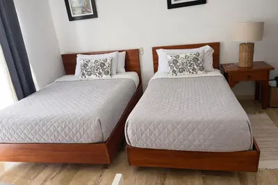 two beds sitting next to each other in a bedroom at Apartamento en Punta Cana, White sands in Punta Cana