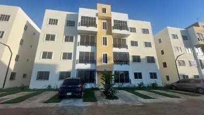 a building with a car parked in front of it at Apartamento Residencial sembrador 3 ciudad Juan Bosch in La Javilla