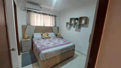 a small bedroom with a bed and a window at Apartamento Residencial sembrador 3 ciudad Juan Bosch in La Javilla