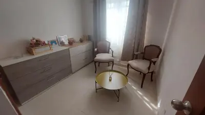 a living room with two chairs and a table at Apartamento Residencial sembrador 3 ciudad Juan Bosch in La Javilla