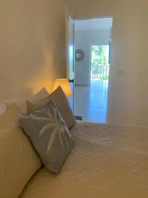 a bedroom with a bed with two pillows on it at Beachfront Unit with Stunning Sunsets and Starlink Internet ! in Las Terrenas