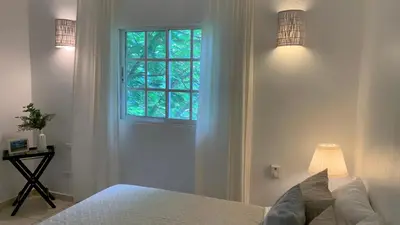 a bedroom with a bed and a window at Beachfront Unit with Stunning Sunsets and Starlink Internet ! in Las Terrenas
