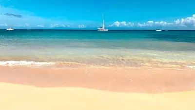 a sandy beach with boats in the ocean at Modern Zen Villa Next to Playa Popy in Las Terrenas