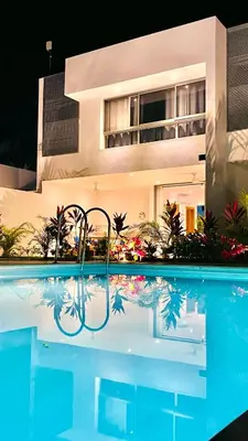 a swimming pool in front of a building at Modern Zen Villa Next to Playa Popy in Las Terrenas