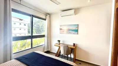 a bedroom with a desk and a bed and a window at Modern Zen Villa Next to Playa Popy in Las Terrenas