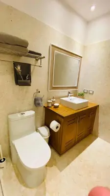 a bathroom with a white toilet and a sink at Modern Zen Villa Next to Playa Popy in Las Terrenas