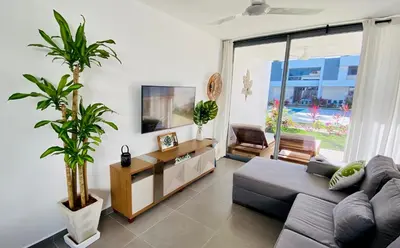 a living room with a couch and a plant at Modern Zen Villa Next to Playa Popy in Las Terrenas