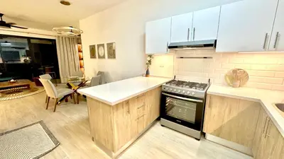 a kitchen with white counters and a stove top oven at All-New Zen Apartment with TreeTops and Ocean Views ! in Las Terrenas
