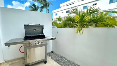 a barbecue grill with a laptop on top of it at All-New Zen Apartment with TreeTops and Ocean Views ! in Las Terrenas