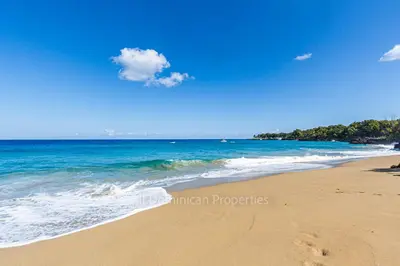 a beach with the ocean and a blue sky at Hispaniola Beach Official, Sosua! in Sosúa