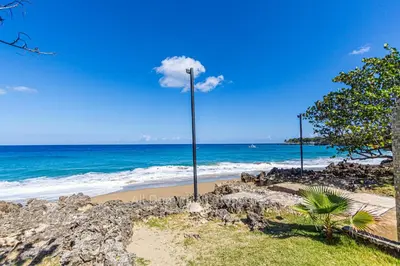 a street light on a beach near the ocean at Hispaniola Beach Official, Sosua! in Sosúa