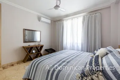 a bedroom with a bed and a mirror and a window at Hispaniola Beach Official, Sosua! in Sosúa