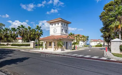 a building with a clock tower on a street at Hispaniola Beach Official, Sosua! in Sosúa