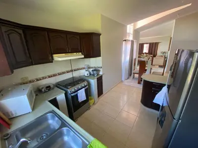 a kitchen with a sink and a refrigerator at My home in San Felipe de Puerto Plata