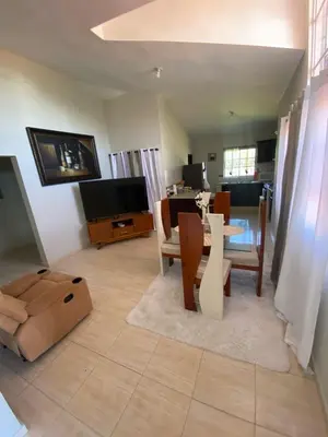 a living room with a table and a dining room at My home in San Felipe de Puerto Plata