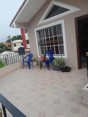 a patio with two blue chairs and a table at My home in San Felipe de Puerto Plata