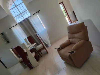 a living room with a chair and a table at My home in San Felipe de Puerto Plata