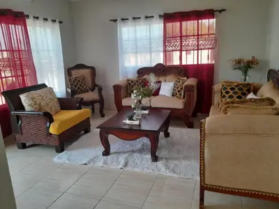 a living room with chairs and a coffee table at My home in San Felipe de Puerto Plata