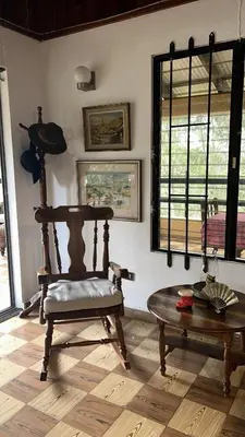 a living room with a chair and a table at Vintage Cabin GB in Constanza