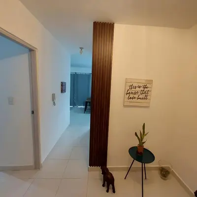 a living room with a table and a hallway at Santo Domingo Este in Ensanche Savica de Mendoza