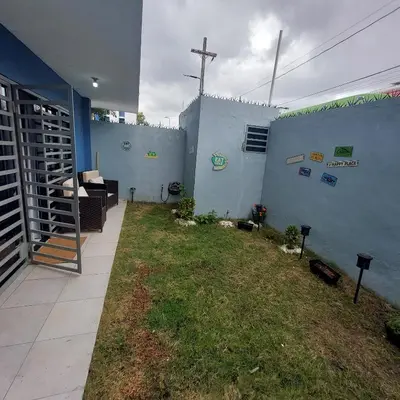 a house with a patio with a grass yard at Santo Domingo Este in Ensanche Savica de Mendoza