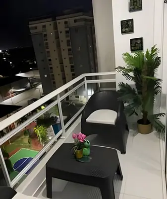 a balcony with a chair and a table on a balcony at Stylish 3BR,2BA in Santo Domingo Este in Mendoza