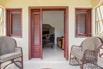 a living room with two chairs and a door at Eden House in Río San Juan