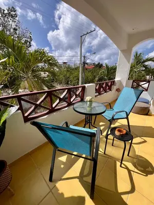 a balcony with two chairs and a table at Apartamento Aurora in Bayahibe