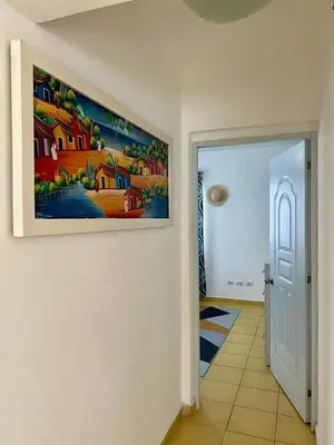 a painting hanging on a wall in a hallway at Apartamento Aurora in Bayahibe