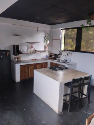 a kitchen with a sink and a stove top oven at Casa Santa la laguna in La Aguada