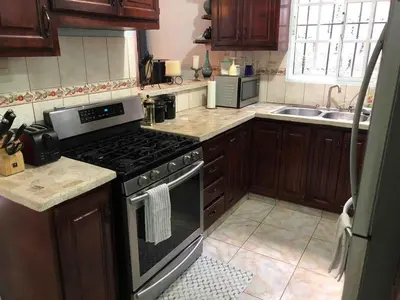 a kitchen with a stove and a sink at Casita Azul in Isabel de Torres