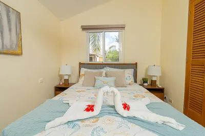 a bedroom with a bed with towels on it at Charming 1 Bedroom in Tamarindo Dominicus With Pool in La Laguna