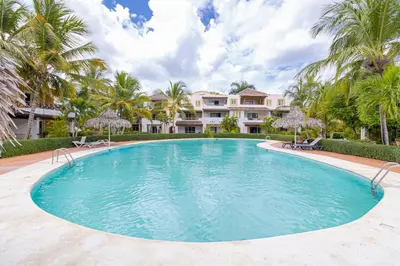 a large swimming pool in front of a house at Charming 1 Bedroom in Tamarindo Dominicus With Pool in La Laguna