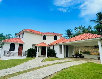 a white house with a red roof at Villa Michel in Laguna del Higüero