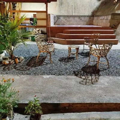 a patio with two chairs and a table and a bench at Estancia La Esperanza in Jarabacoa