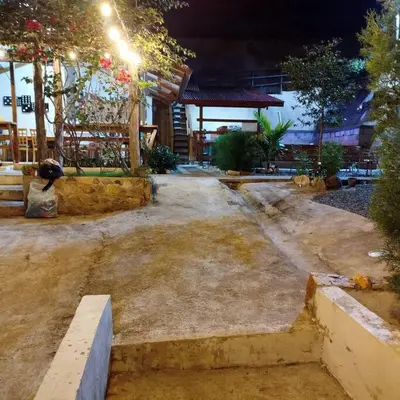 an empty courtyard with a building with lights at Estancia La Esperanza in Jarabacoa
