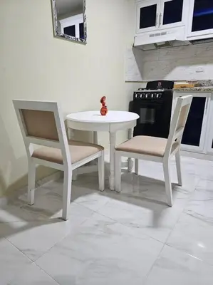 a kitchen with a white table and two chairs at hermoso aparta estudio a 10 minutos del centro in San Felipe de Puerto Plata