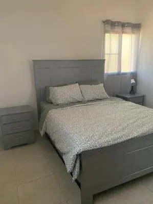 a bedroom with a bed and a window at Jungle Oasis by the Beach in San Felipe de Puerto Plata