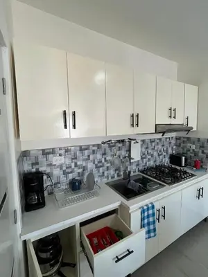 a kitchen with white cabinets and a stove top oven at CGM BLUE 1hab in Bayahibe
