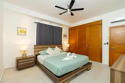 a bedroom with a bed and a ceiling fan at Elegant 2 Bedroom Apartment with Pool in La Laguna