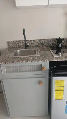 a kitchen counter with a sink and a refrigerator at Cadaques Caribe Palmera 101 in Bayahibe