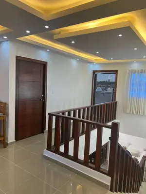 a lobby with a wooden staircase and a door at Con in Santo Domingo