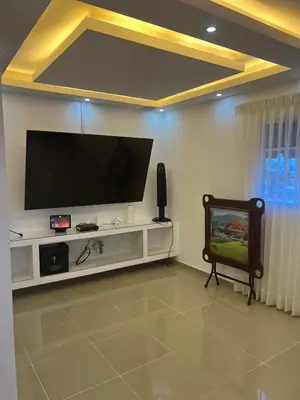 a living room with a flat screen tv on a wall at Con in Santo Domingo