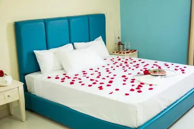 a blue bed with red hearts on it at Hotel El Imperio Punta Cana in Punta Cana