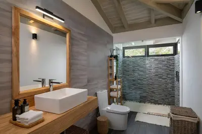 a bathroom with a white sink and a shower at Villa Laguna, Lush Oasis In Casa De Campo in La Romana